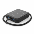 4-in-1 portable GaN charging hub in matte black showing USB-C ports and wireless charging pad, flat lay on white background