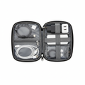 Travel organizer bag open showing mesh pockets and elastic loops with USB cables and adapters, flat lay top-down view on white background